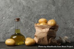 Kitchen counter with olive oil and bag of potatoes 41grg0
