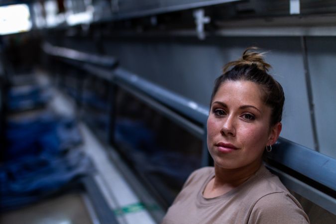 Military woman looking up inside vehicle