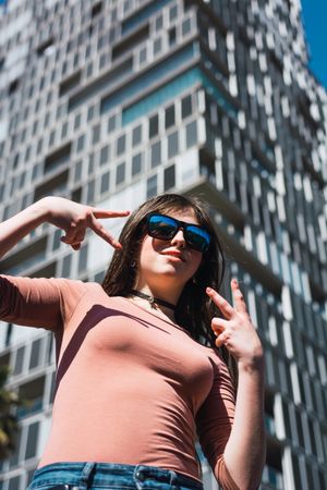 Portrait of 16 year old girl making funny gestures.