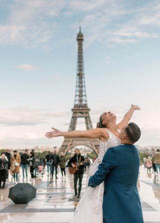 Happy newlyweds in wedding clothing dancing together