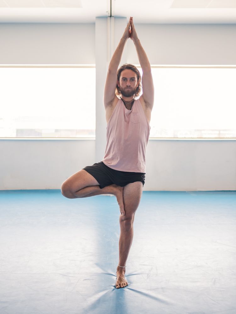 Male doing yoga in spacious room
