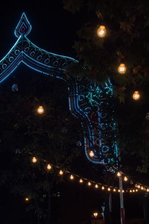 Illumination garlands on fairground at night