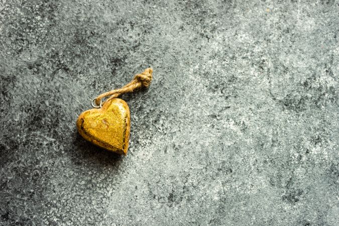 Valentine's day concept with golden heart shaped ornament on grey counter