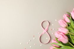 Pink tulips, candies in heart shape and 8 on grey background, space for text