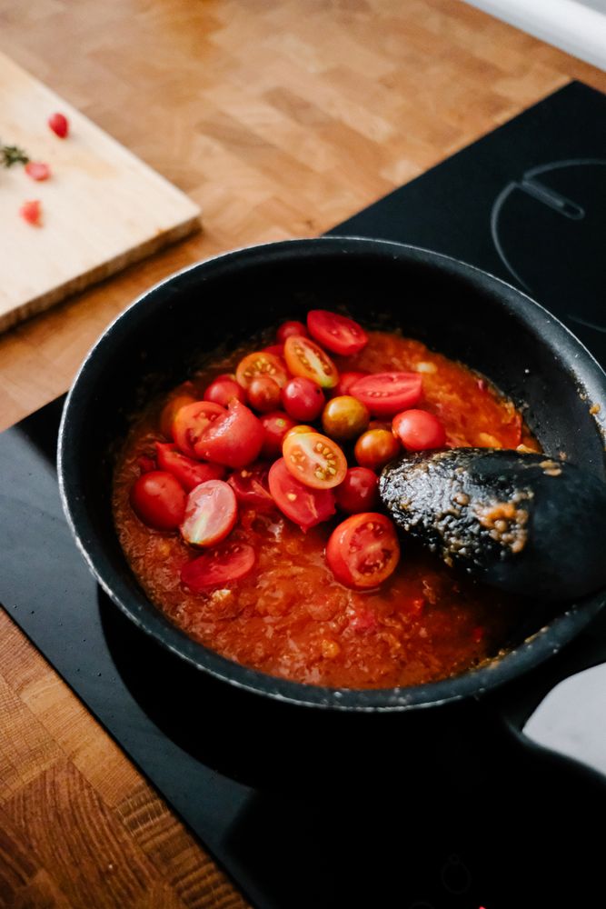 Cherry tomatoes freshly added to sauce