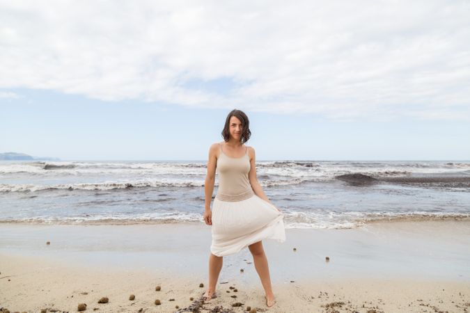 Charming young woman on shore near water