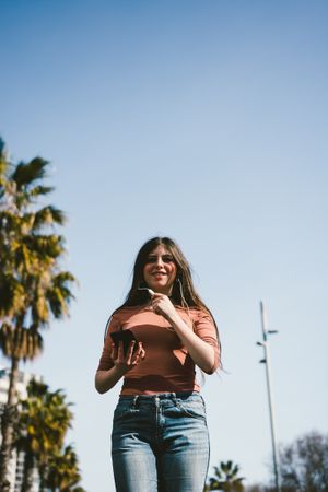 Teen girl walking happily through the streets.
