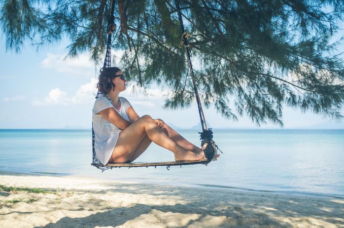 Woman in hammock near sea