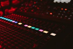 DJ music board with light buttons in club