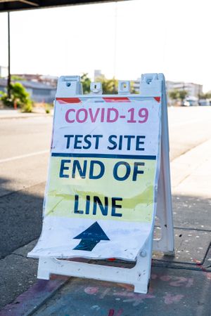 Sign on street indicating end of line for COVID-19 test site