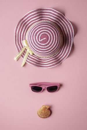 Girly beach accessories on pink background