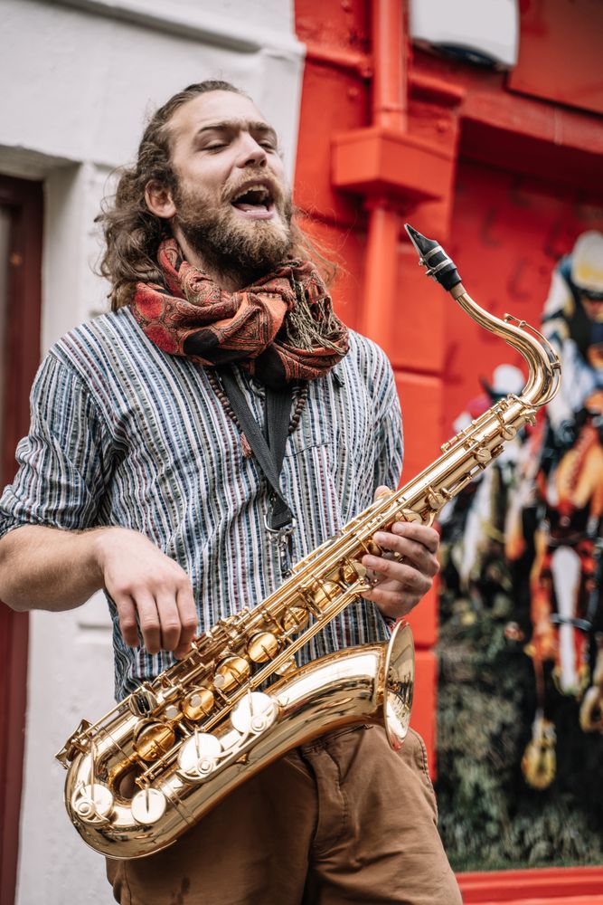 Male saxophonist plays Sax in the street