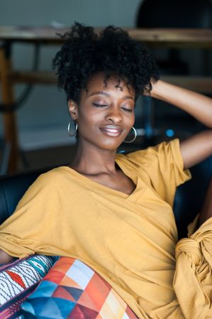 Portrait of beautiful woman with natural hair smiling with eyes closed