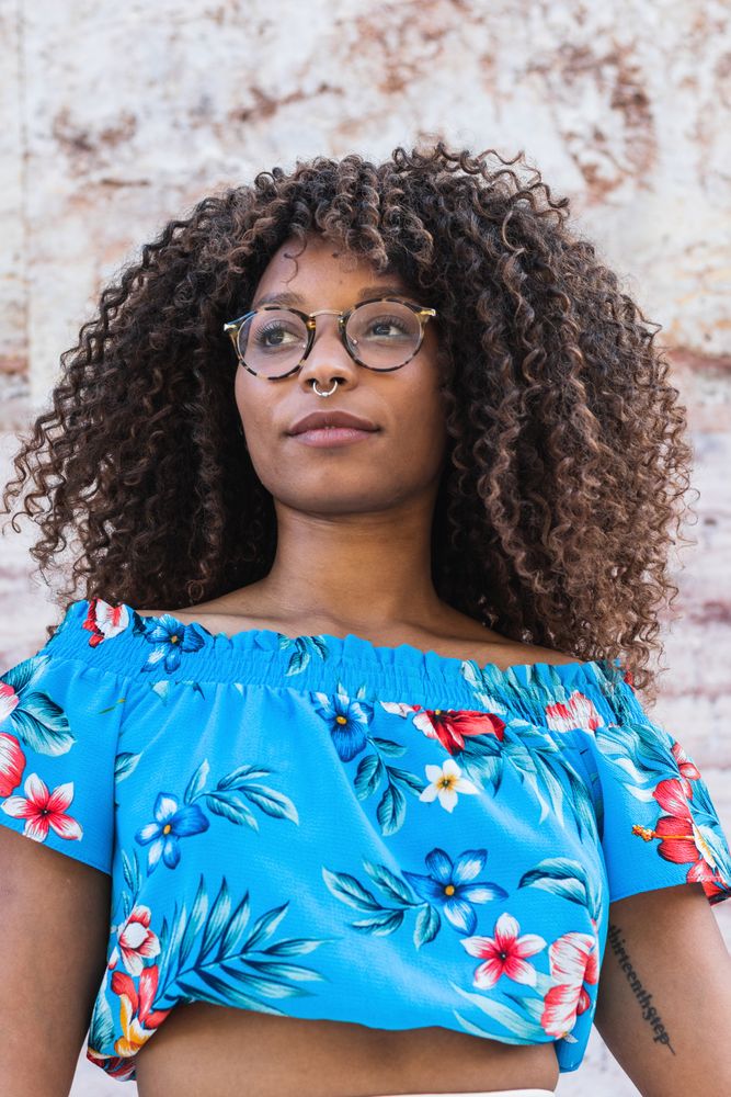 Trendy Black female near marble wall
