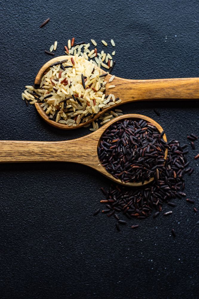 Top view of two spoons with rice