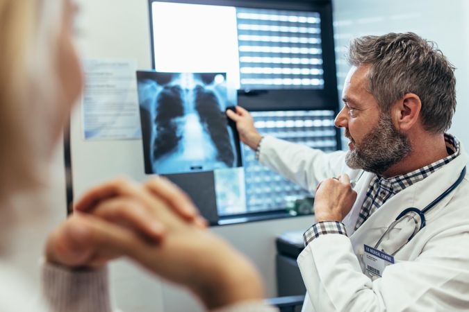 Doctor discussing scan results with patient in clinic