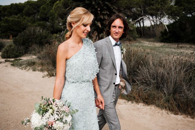 Happy newlyweds at nature after ceremony