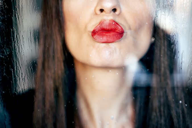 Stylish woman kissing glass