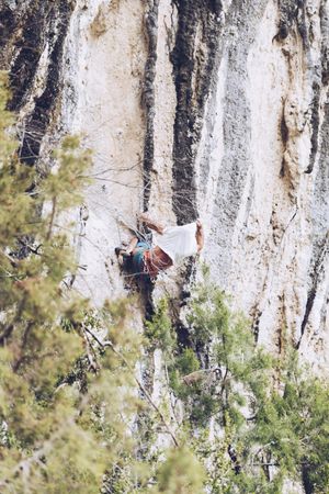 Anonymous man climbing rock