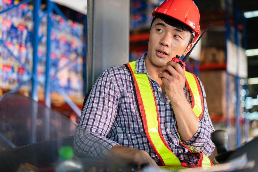 Man in PPE gear using radio