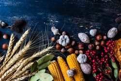 Top view of wooden table with seasonal nuts, berries, vegetable and fruits for autumn season