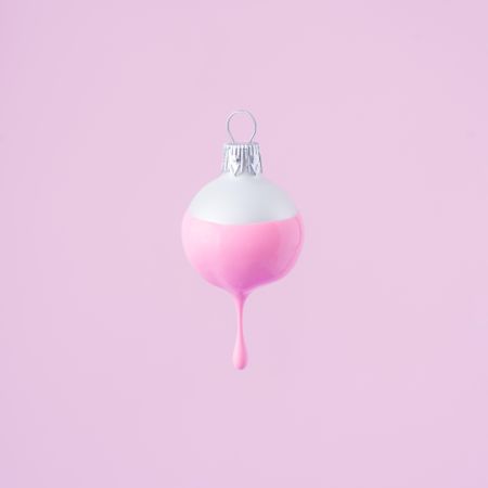 Christmas bauble decoration with pastel pink paint dripping