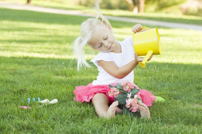 Cute Little Girl Playing Gardener with Her Tools and Flower Pot.