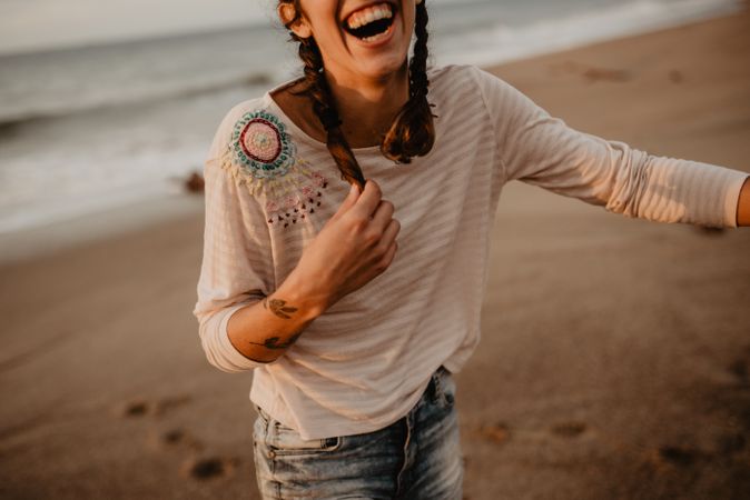 Young woman laughing on beach