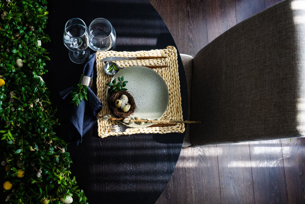 Top view of Easter table setting with placemat and elegant chair