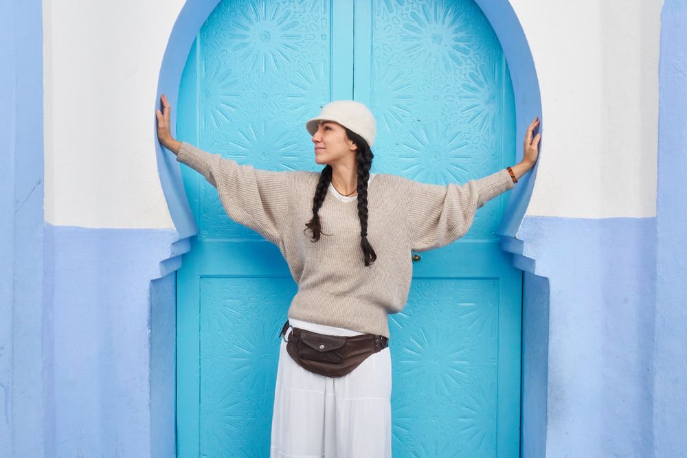 Smiling woman posing near vintage door