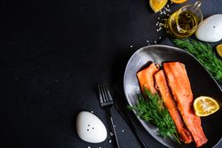 Top view of herring fish with dill and lemon served on plate