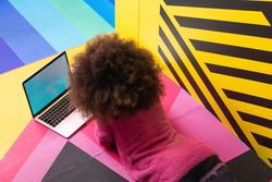 Anonymous Black girl using laptop in studio