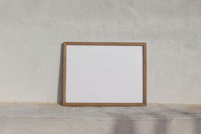 Blank poster frame on sunny outside