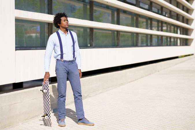 Man outside his office with skateboard