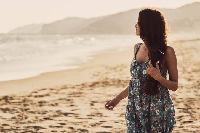 Young woman in the beach at sunset