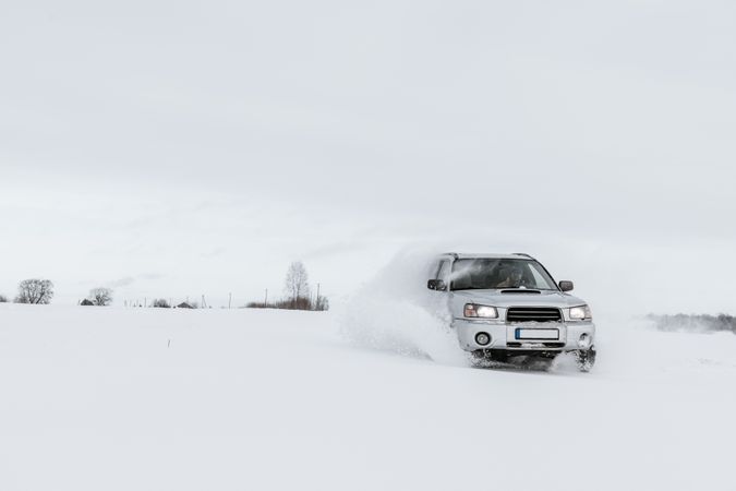 Car driving on snow field