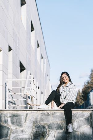 Young woman posing with skateboard