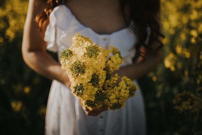Woman with flowers in field