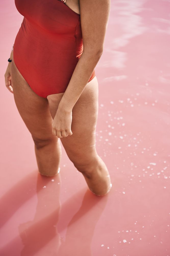 female in swimsuit posturing on beach