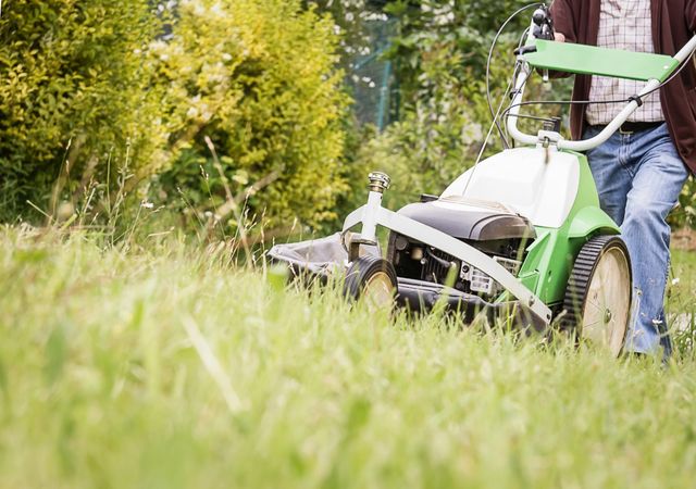 man mowing the lawn with a lawnmower