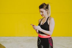 Woman with earphones using smartphone
