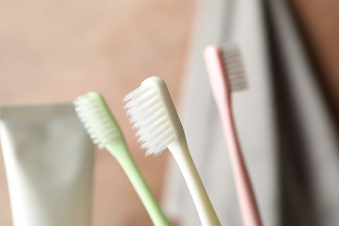Toothbrushes, tube and towel, close up. Dental care