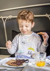Child having breakfast in bed