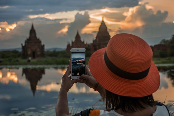Female tourist taking picture of temples