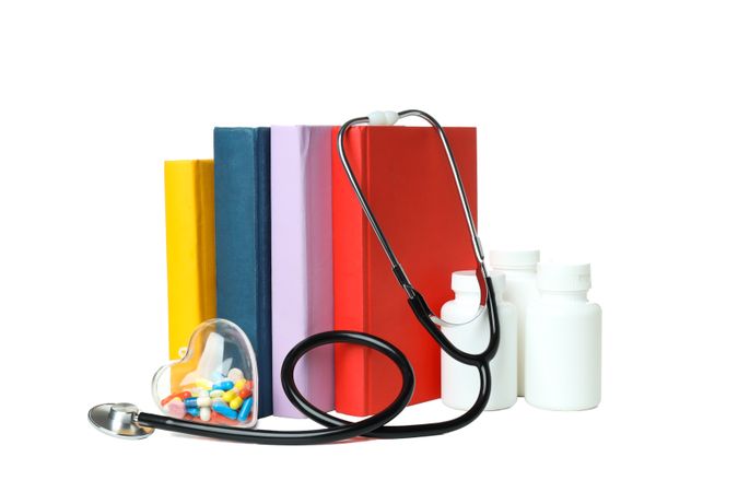 Concept of different professional books - medicine books, isolated on light background