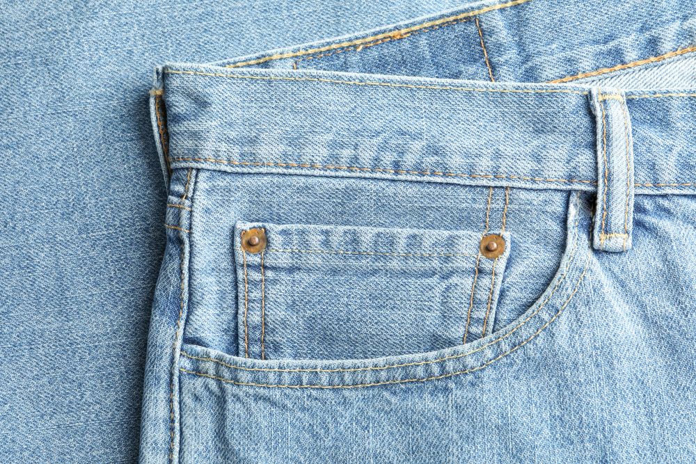 Closeup view of jeans pocket as background, space for text