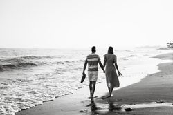 Adult couple walking towards sea