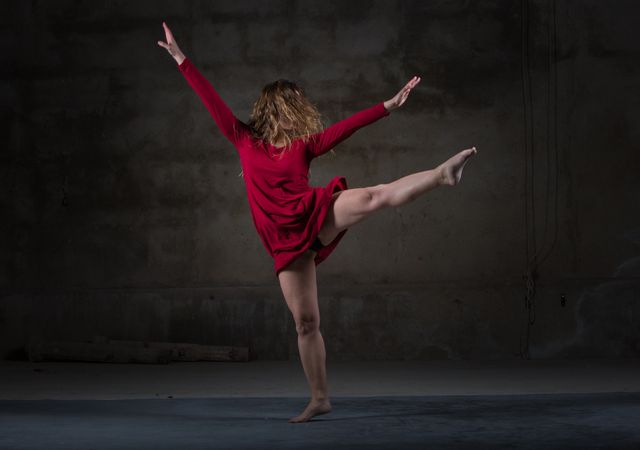 Young woman dancing in darkness