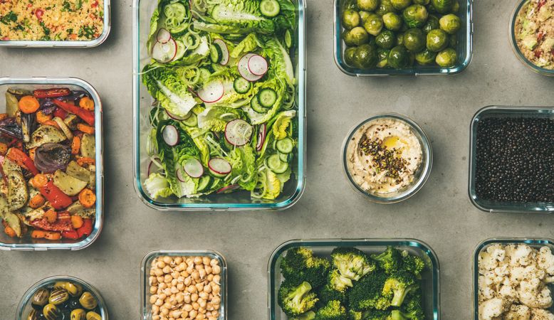 Variety of vegetable dishes arranged in glass containers