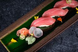 Delicious sushi rolls with tuna served on wooden plate